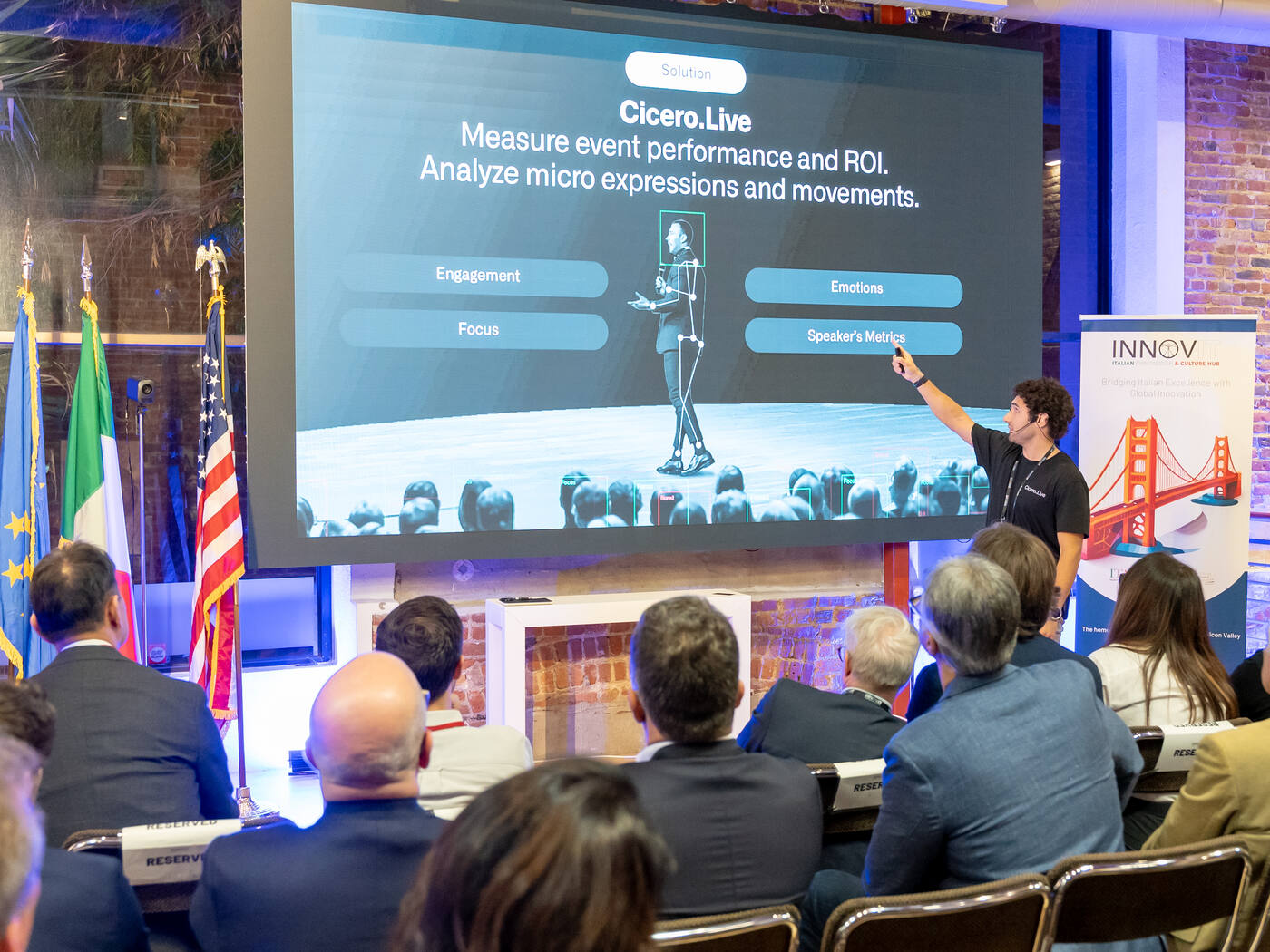 Speaker presenting event metrics on screen