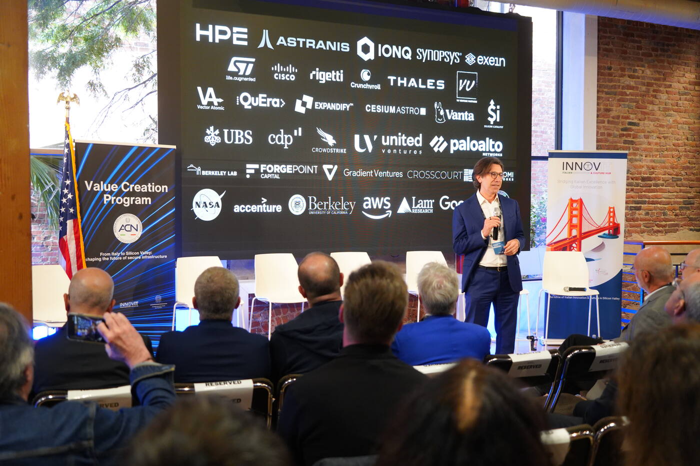 Audience in front of a sponsor wall