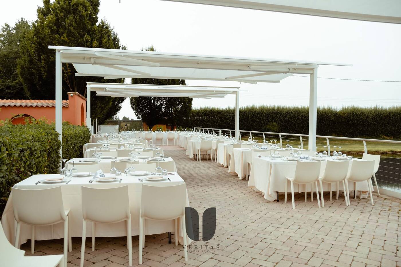 Long white tables under a pergola